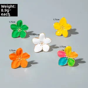 Detailed view of 1.75cm baroque floral rings with colorful enamel finish and gold center