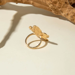 Vintage gold lava flower ring with hammered metal texture and organic floral design