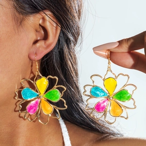 Detailed view of large gold-tone bohemian floral drop earrings with colorful enamel petals