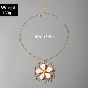 Detail of gold flower pendant necklace with white enamel petals and lobster clasp closure