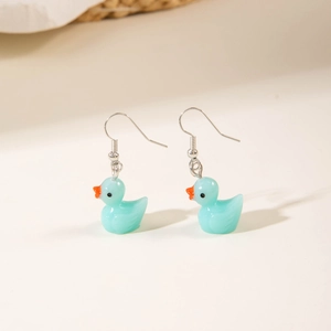 Detailed view of light blue resin duck earrings with glossy finish and silver hooks
