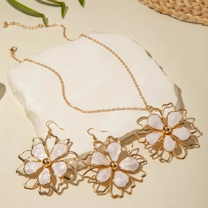 Luxury gold necklace and earrings set with oversized white enamel flower petals