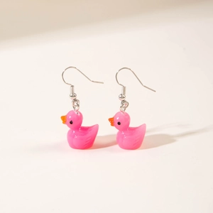 Cute pink resin duck earrings for women with silver metal hooks on a cream background