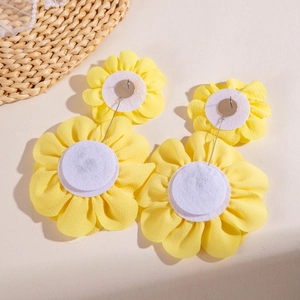 Detail of yellow fabric flower earrings showing the secure metal post and felt backing