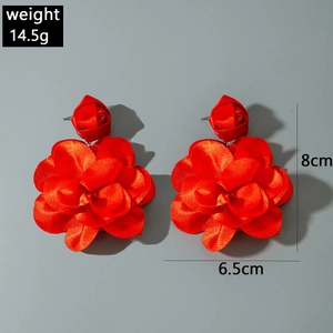 Macro detail of red fabric flower earrings with dimensions and weight specifications