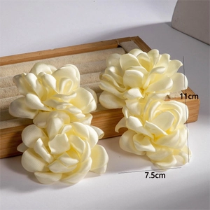 Detailed dimensions of 11cm cream satin flower earrings on a soft display tray