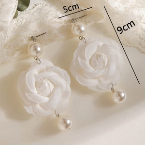 Detail shot of white fabric rose earrings with pearls showing dimensions of 9cm by 5cm