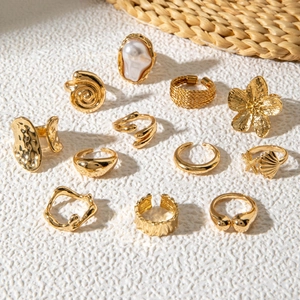 Detail of 11-piece gold ring set featuring pearl, starfish, and floral bohemian designs
