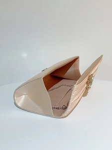 Détail de la pochette de soirée en satin champagne avec plis et boucle en strass