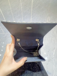 Black evening clutch with sparkling rhinestones, metal chain and magnetic closure