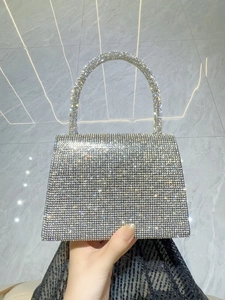 Macro detail of silver rhinestones and craftsmanship on luxury evening handbag