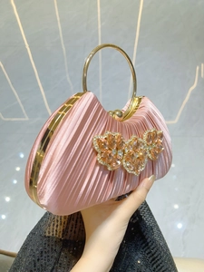 Pink satin evening clutch bag with round gold metal handle and rhinestone floral accents