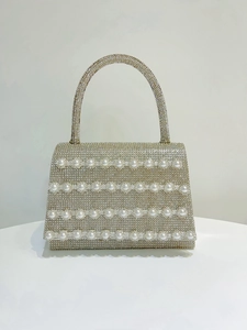 Detailed front view of luxury banquet handbag with shimmering rhinestones and pearls