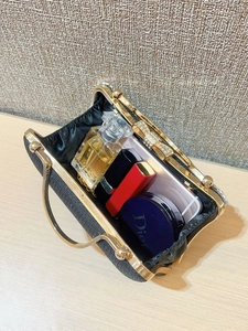 Detail view of the black glitter evening clutch showing internal space for phone and makeup