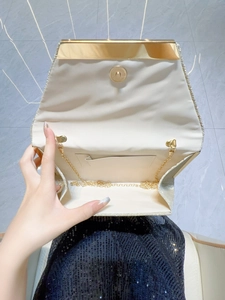 Sparkling gold sequin evening clutch bag with metal frame and detachable chain strap