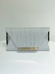 Detail of silver glitter evening clutch with elegant vertical pleats and metal trim