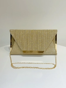 Close-up of gold glitter pleated envelope evening clutch with metallic trim and chain