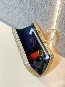 Internal view showing capacity of the gold sequin evening clutch with metal handle