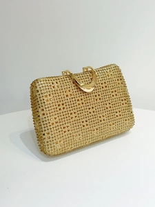 Detailed side view of luxury gold evening clutch bag with sparkling rhinestones decoration