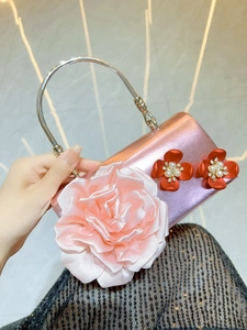 Pink satin evening clutch with large 3D fabric rose and silver metal handle for weddings