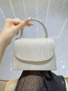 Close-up of sparkling silver rhinestones on the luxury handle and evening bag flap