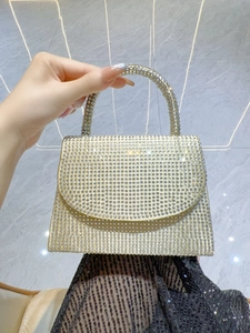 Detailed view of champagne gold evening bag with dense sparkling crystal rhinestones