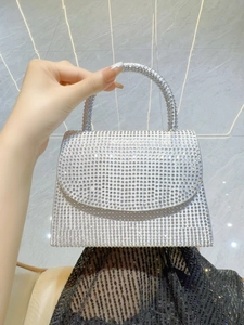 Macro shot of silver rhinestone evening handbag showing the glittering crystal details