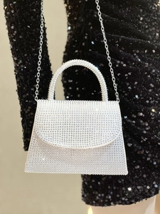 Macro detail of sparkling full rhinestone surface on luxury evening clutch handbag