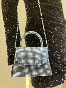 Detailed macro view of sparkling silver rhinestones on luxury evening clutch handbag