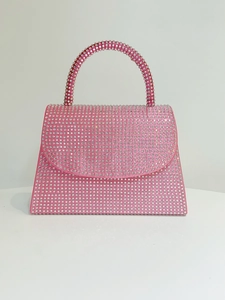 Close-up of pink satin evening handbag with shimmering silver rhinestones and handle
