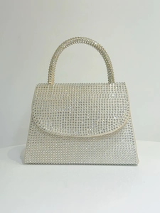 Detailed view of silver rhinestones on luxury evening handbag with crystal-encrusted handle