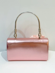Rose gold metallic evening clutch bag with circular silver handle and floral decor