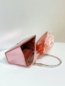 Detail of pink metallic evening bag with 3D fabric flowers and silver chain strap