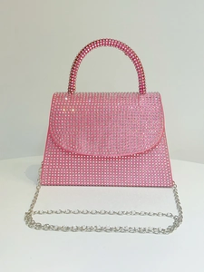 Close-up of pink crystal evening bag with shimmering rhinestones and silver chain