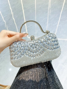Close-up of sparkling silver rhinestone evening clutch with geometric crystal patterns