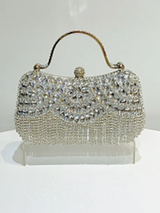 Detail of silver rhinestone evening clutch with floral crystal patterns and fringe tassels