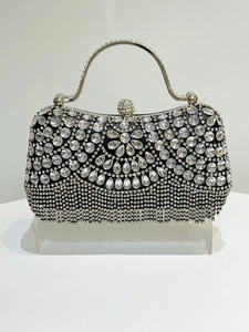 Detail of luxury crystal evening clutch featuring a radial floral rhinestone pattern