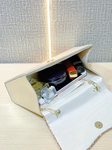 Internal view of the gold sequin evening clutch bag showing space for cosmetics