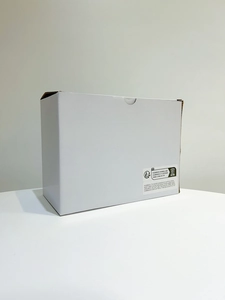 Detailed view of the white rectangular paper packaging box with environmental logo