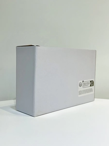 Detailed view of minimalist white packaging box with standard safety and compliance labels