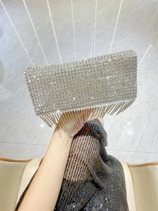 Detail of silver rhinestone evening clutch with sparkling tassels and rectangle frame