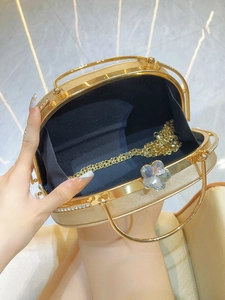 Elegant gold oval evening clutch bag with crystal flower clasp and detachable chain strap