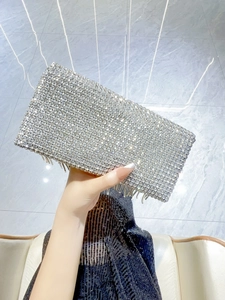 Detailed close-up of sparkling silver rhinestone evening clutch bag with fringe tassels