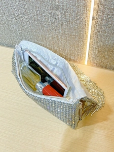 Internal view of silver rhinestone clutch bag showing space for phone and makeup