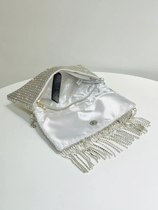 Internal view of silver rhinestone evening bag showing satin lining and metal chain strap