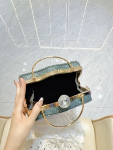 Sparkling dark green rhinestone evening clutch bag with round gold handle and crystal clasp