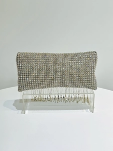 Detail view of silver rhinestone fringe and sparkling crystals on evening clutch bag