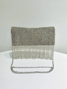 Detail view of silver rhinestone evening bag featuring shimmering crystal fringe and metal chain