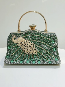 Detailed view of peacock rhinestone evening bag with intricate crystal inlay and gold handle