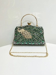 Detail of green crystal peacock evening clutch with golden handle and metal chain